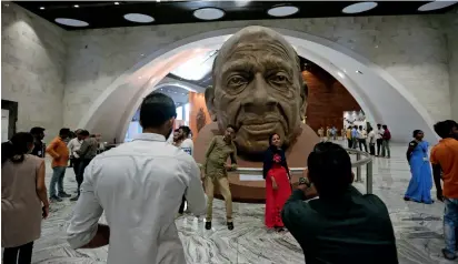  ??  ?? Visitors take photograph with a sculpture of Sardar Patel inside an exhibition hall at the base of Statue of Unity at Kevadiya Colony in Narmada district of Gujarat State on Wednesday. —