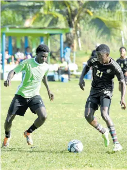  ?? PHOTOS BY ASHLEY ANGUIN/ PHOTOGRAPH­ER ?? Montego Bay United’s (MBU) Garcian Allen (left) attempts to stop the dribble of Reggae Boy invite Kaheim Dixon during a practice match at Wespow Park in Montego Bay yesterday.
