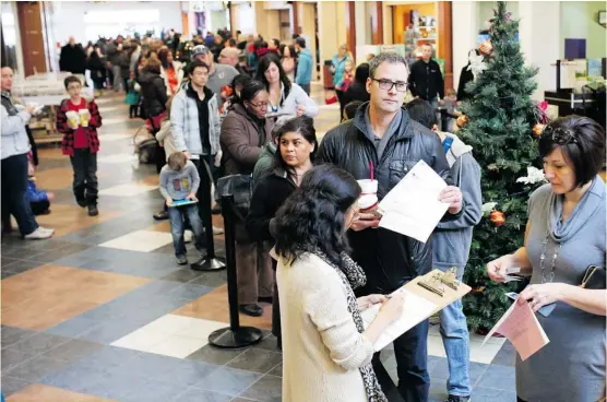  ?? Photos: Gavin Young, Calgary Herald ?? It was a long wait at the Brentwood Village Mall flu clinic on Thursday as hundreds of Calgarians sought to avoid the recent spike of flu in the province.