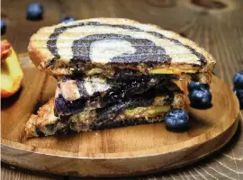  ?? TERRENCE ANTONIO JAMES Chicago Tribune/TNS ?? Peanut butter and jelly panini is served with a fresh peach and berries.