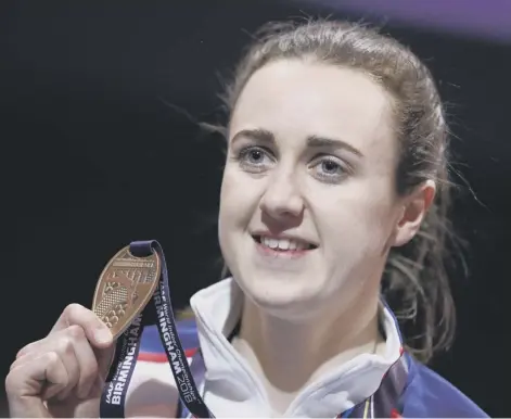  ??  ?? 0 A beaming Laura Muir with her bronze medal after the podium ceremony for the 3,000m at the World Indoor Championsh­ips.