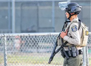  ?? CHRIS SMEAD/REUTERS ?? A police officer stands watch at the scene of a mass shooting during the Gilroy Garlic Festival in Gilroy, Calif., Sunday.