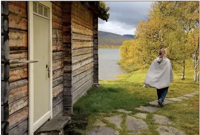  ??  ?? Anki Vinka runs the Sami Ecolodge alongside her husband, Mikael. While kerosene lamps are used at the secluded lodging, electricit­y and running water are not available.