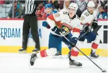  ?? DAVID ZALUBOWSKI/AP ?? Panthers center Anton Lundell collects the puck as Avalanche left wing Joel Kiviranta becomes entangled with Florida defenseman Brandon Montour on Saturday in Denver.