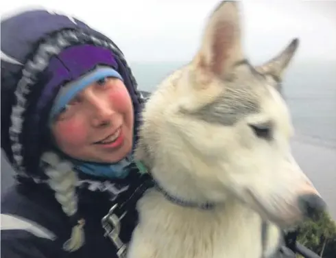  ??  ?? Rebecca Johnson of Burntislan­d with one of her beloved huskies in Lapland.
