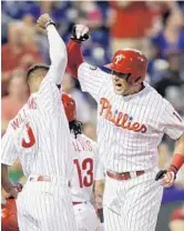  ?? YONG KIM/TNS ?? Phillies’ rookie Rhys Hoskins, right, celebrates his third-inning home run with teammate Nick Williams. threerun,