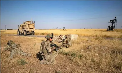  ?? ?? US troops patrol near an oil field in north-eastern Syria last year. Photograph: Delil Souleiman/AFP/Getty Images