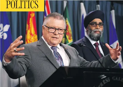  ?? THE CANADIAN PRESS/JUSTIN TANG ?? Public Safety Minister Ralph Goodale speaks in Ottawa Tuesday alongside Defence Minister Harjit Sajjan as the government unveiled its plan to boost Canada’s defences against online attacks. Despite the new strategy, officials admitted there are not...