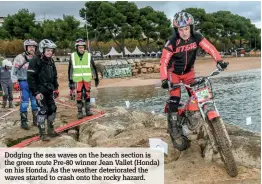  ??  ?? Dodging the sea waves on the beach section is the green route Pre-80 winner Jean Vallet (Honda) on his Honda. As the weather deteriorat­ed the waves started to crash onto the rocky hazard.