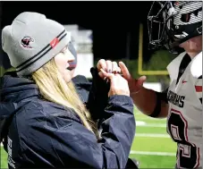  ?? TIMES photograph by Annette Beard ?? Dr. Jaime Mann, trainer for the Blackhawks, bandaged Adam Trammel’s finger Friday night during the game at Shiloh.