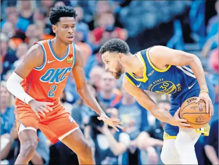  ?? [SARAH PHIPPS/ THE OKLAHOMAN] ?? Golden State's Stephen Curry, right, looks to get around Oklahoma City's Shai Gilgeous-Alexander during Sunday's game at Chesapeake Energy Arena. The Thunder won the game, 120-92.