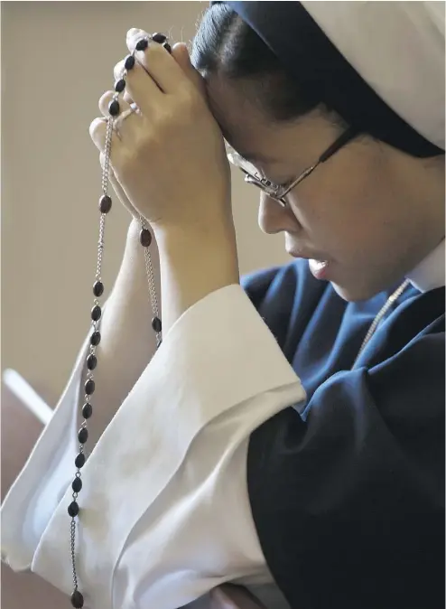  ?? PETER J. THOMPSON / NATIONAL POST ?? Sister Marita de la Fuente prays at the The Sisters of Life mission centre in Toronto. The Sisters of Life is a convent of young, ultra-conservati­ve Catholic nuns that was founded in New York in 1991, and arrived in Canada in 2007.