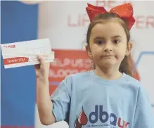  ??  ?? Chloe Gray with one of the DKMS swab kits used to find stem cell donors.