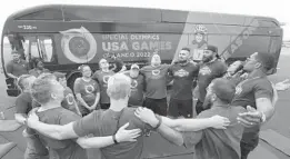  ?? ORLANDO SENTINEL RICARDO RAMIREZ BUXEDA/ ?? Special Olympics athletes and WWE wrestlers huddle before a workout during the Special Olympics USA Countdown Event at the Orlando Executive Airport on March 9. The 2022 Special Olympics USA Games will be held in Orlando June 5-12.