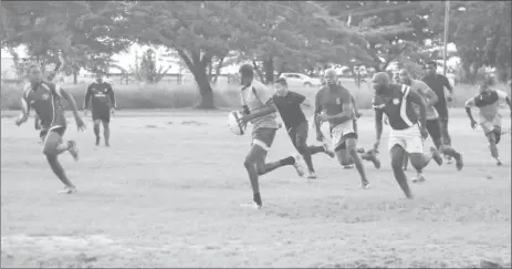  ?? (Orlando Charles photo) ?? The Green Machine practicing yesterday in the swampy National Park rugby field. Despite the recent inclement weather, the spirit of the national rugby squad is far from dampened.