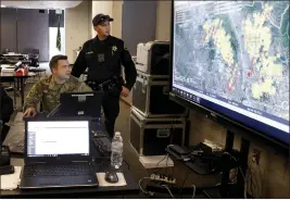  ?? KARL MONDON — BAY AREA NEWS GROUP ?? Alameda County sheriff’s deputy Mike Ziller, right, works with 1st Sgt. James Dokken of the California National Guard at the Sonoma County Sheriff’s Office during the Tubbs Fire in Santa Rosa in 2017.