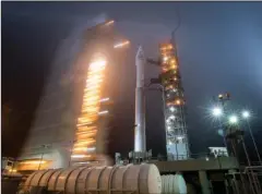  ?? The Associated Press ?? MISSION TO MARS: In this photo released by NASA, the mobile service tower at SLC-3 is rolled back Friday to reveal the United Launch Alliance Atlas-V rocket with NASA’s InSight spacecraft on board at Vandenberg Air Force Base in California. The rocket launched early Saturday.