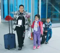  ?? (Rebecca Cook/Reuters) ?? IRAQI REFUGEE Amira al-Qassab and her children arrive at Detroit Metro Airport on Friday.