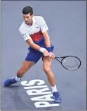  ?? Justin Setterfiel­d / Getty Images ?? Novak Djokovic plays a backhand during his singles semifinal match against Hubert Hurkacz at the Paris Masters on Saturday.