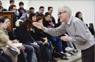  ??  ?? Marvin Karon conducting a class on Hamlet at Sir John A. Macdonald in Hamilton, one of 135 schools to have the "Shakespear­ience."