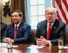  ?? Jabin Botsford/The Washington Post ?? Ron DeSantis, then-Florida governor-elect, listens as then-President Donald Trump speaks during a meeting with governors-elect at the White House in 2018.