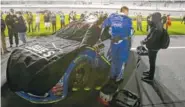  ?? THE ASSOCIATED PRESS ?? Jimmie Johnson’s car is covered on pit road during a rain delay before the NASCAR Clash race at Daytona Internatio­nal Speedway on Saturday. The race was delayed to Sunday.
