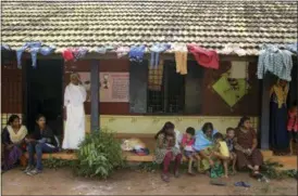  ?? AIJAZ RAHI — THE ASSOCIATED PRESS ?? Women and children who have left their flood affected homes spend time at a relief camp set up at a government run school in Alappuzha in the southern state of Kerala, India, Monday. Kerala has been battered by torrential downpours since Aug. 8, with floods and landslides killing at least 250 people. About 800,000 people now living in some 4,000 relief camps.