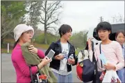  ?? Diane Wagner / Rome News-Tribune ?? Visitors from Kumamoto, Japan, (from left) Ayaka Hori, Shino Kazaki and Yuka Hashimoto arrive at Jackson Hill for the next stage of their exchange student program activities after spending Monday morning at State Mutual Stadium.