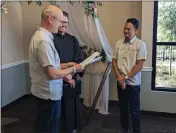  ?? ?? Christophe­r Hest marries his partner of 14years, Louie Abid in Oroville on Tuesday with Clerk-Record Keaton Denlay officiatin­g the ceremony.