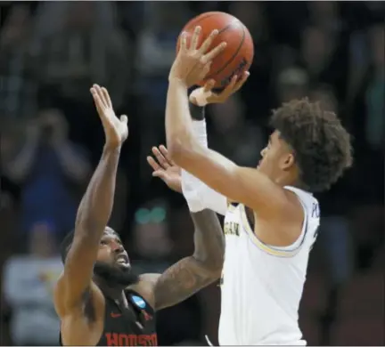  ?? THE ASSOCIATED PRESS ?? FILE - This file photo shows Michigan guard Jordan Poole shooting a 3-point basket over Houston guard Corey Davis Jr.