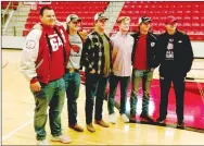  ?? MARK HUMPHREY ENTERPRISE-LEADER ?? Classmates and high school football teammates (from left): Chuck Carlson, Jacob Rogers, Jacob Freeman, Reid Turner, Eric Hill, and Seth Swain celebrate as Turner signs a national letter of intent to walk-on with the University of Arkansas football program on Thursday at Cardinal Arena. The group holds one another accountabl­e and strove for excellence on the football field regardless of score.