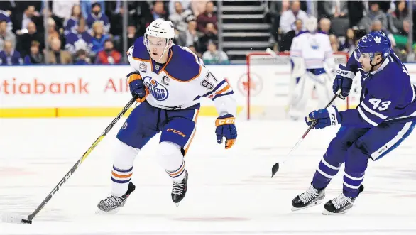  ?? NATHAN DENETTE/THE CANADIAN PRESS/FILES ?? Edmonton Oilers centre Connor McDavid, left, is the choice to repeat as league MVP and scoring champion in a recent poll of 25 top players.