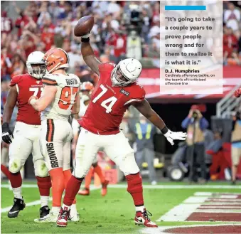  ?? GETTY IMAGES ?? D.J. Humphries (74) spikes the football after a teammate’s score against the Browns on Dec. 15. Humphries anchored the left side of the Cardinals’ offensive line last season, allowing just two sacks.