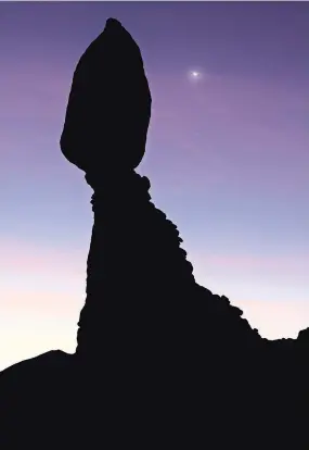  ?? JOHN BURCHAM FOR THE NEW YORK TIMES ?? A view of Venus before sunrise at Balanced Rock in Arches National Park in Utah.