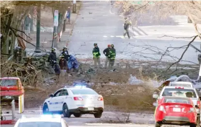  ??  ?? ABOVE: Authoritie­s on Saturday examine the scene of a Christmas Day explosion in Nashville, Tenn.
LEFT: As part of the investigat­ion, FBI and ATF agents search a home Saturday.