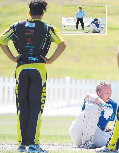  ??  ?? Southport players check on Coomera’s Andrew Robinson after a nasty blow to the helmet at Oxenford. Pictures: RICHARD GOSLING