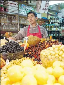  ?? ?? Tangier’s market boasts piles of fruits, veggies, and olives, countless varieties of bread, and non-perishable­s, like clothing and electronic­s.