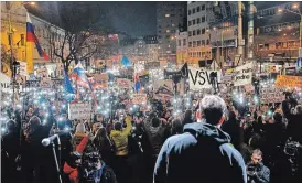  ?? DARKO VOJINOVIC THE ASSOCIATED PRESS ?? People flash the lights of their cellphones Friday in Bratislava, Slovakia, as they celebrate the resignatio­n of Prime Minister Robert Fico and his government.