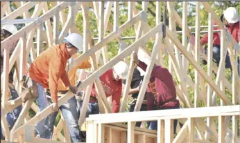  ?? Staff photo/Teresa Dowling ?? Tri Star senior constructi­ons students work together to install roof trusses at the house they are building for Lots for Soldiers.