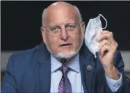  ?? ANDREW HARNIK ?? Centers for Disease Control and Prevention Director Dr. Robert Redfield holds up his mask as he speaks at a Senate Appropriat­ions subcommitt­ee hearing on a “Review of Coronaviru­s Response Efforts” on Capitol Hill, Wednesday, Sept. 16, 2020, in Washington.