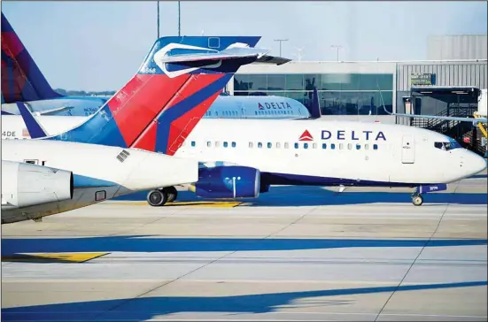  ?? ?? A Delta Airlines aircraft taxi’s Thursday, Dec. 2, 2021, at Hartsfield-Jackson Atlanta Internatio­nal Airport, in Atlanta. Delta Air Lines lost $940 million in the first quarter, Wednesday, April 13, 2022, yet bookings surged in recent weeks, setting up a breakout summer as Americans try to put the pandemic behind them. While Delta’s revenue is recovering, the Atlanta airline faces stiff headwinds from higher spending on fuel and labor. (AP)