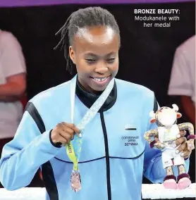  ?? ?? BRONZE BEAUTY: Modukanele with her medal