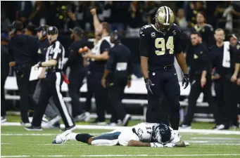  ?? ASSOCIATED PRESS ?? NICE HANDS: Cameron Jordan (94) stares down at Alshon Jeffery, who could not handle a pass that turned into a game-clinching intercepti­on in the Saints’ 20-14 victory against the Eagles yesterday in New Orleans.