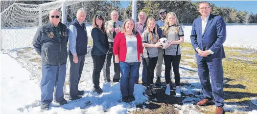  ?? CONTRIBUTE­D ?? Community members and politician­s recently gathered to celebrate the announceme­nt of $500,000 in provincial funding to help install lights at the Greenwood soccer field.