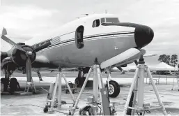  ?? COURTESY OF THE BERLIN AIRLIFT HISTORICAL FOUNDATION ?? A C-54 gets refurbishe­d so it can fly in reenactmen­ts of “candy drops” done for children in Berlinafte­r World War II.