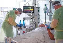  ?? (AFP) ?? Senior doctor Thomas Marx (right) talks to a COVID-19 patient in an intensive care unit of a hospital in Freising, in southern Germany on Monday