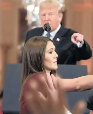  ??  ?? Donald Trump tells Jim Acosta, “That’s enough,” as the intern microphone in his hand. reaches for the