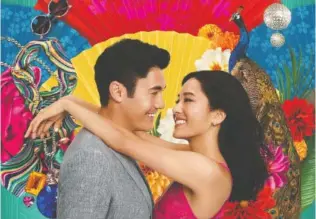  ?? WARNER BROS. ?? Constance Wu, right, plays an American-born economics professor who visits Singapore to meet the family of her boyfriend, played by Henry Golding, in “Crazy Rich Asians.”