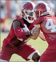  ?? NWA Democrat-Gazette/ANDY SHUPE ?? Arkansas freshman defensive back Joe Foucha (left) overcame a home life in New Orleans that was disrupted by Hurricane Katrina, and he displayed enough confidence to stand and speak during an early team meeting with the Hogs.