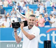 ?? AP ?? Australia’s Nick Kyrgios holds the trophy after his victory at the Washington Open.